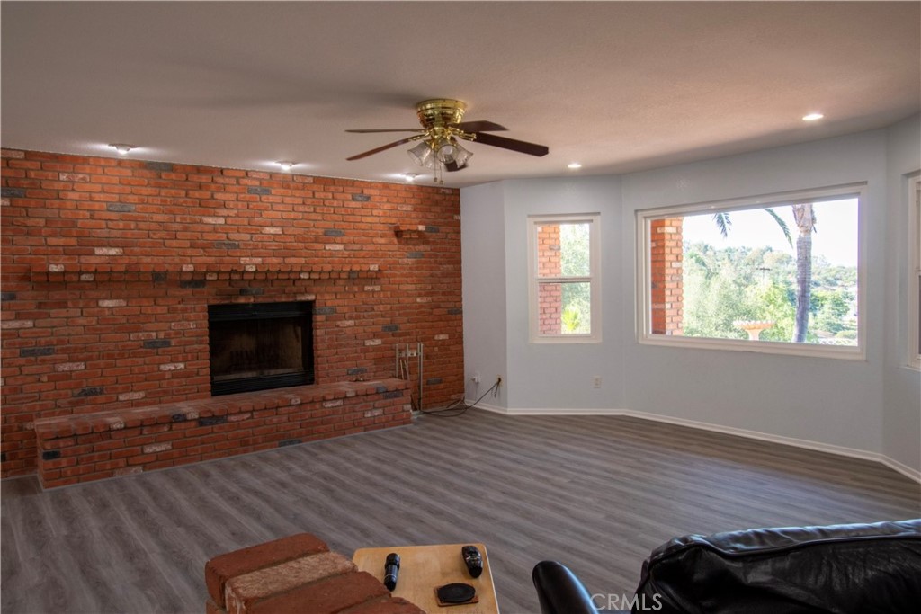 17595 Rancho De La Angel Road Ramona, CA 92065 - Photo 19 of 63 a view of an empty room with a fireplace and a window