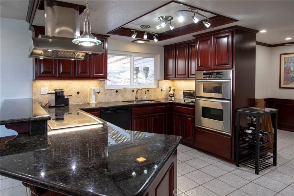 17595 Rancho De La Angel Road Ramona, CA 92065 - Photo 28 of 63 a kitchen with stainless steel appliances granite countertop a sink stove and refrigerator