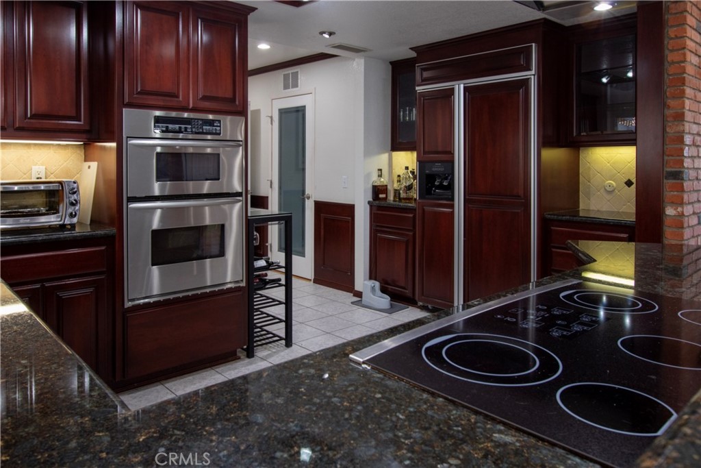 17595 Rancho De La Angel Road Ramona, CA 92065 - Photo 30 of 63 a kitchen with a refrigerator and a stove