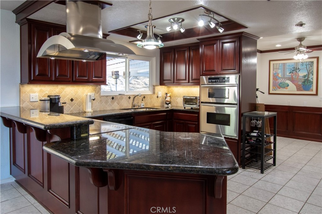 17595 Rancho De La Angel Road Ramona, CA 92065 - Photo 31 of 63 a kitchen with stainless steel appliances granite countertop a sink a stove and cabinets
