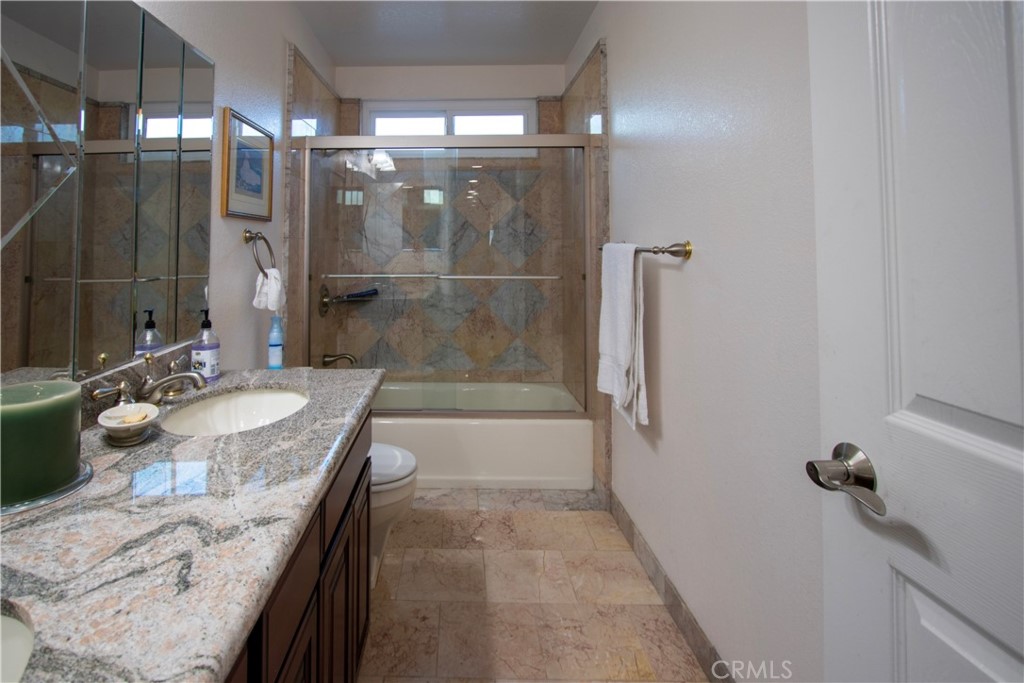 17595 Rancho De La Angel Road Ramona, CA 92065 - Photo 44 of 63 a bathroom with a granite countertop sink a toilet and shower