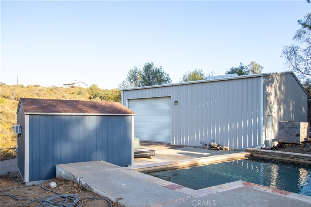 17595 Rancho De La Angel Road Ramona, CA 92065 - Photo 54 of 63 a backyard of a house with a yard and garage