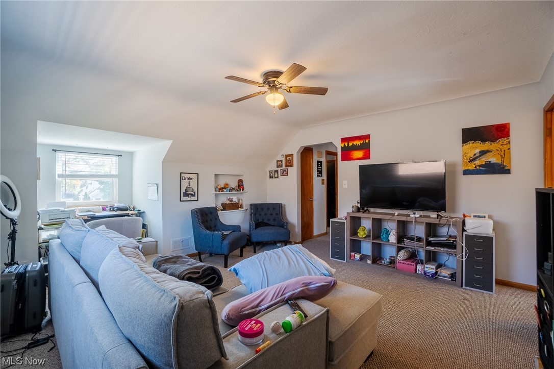 15022 Triskett Road Cleveland, OH 44111 - Photo 21 of 35 Carpeted living room with ceiling fan and lofted ceiling