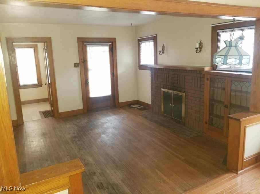 218 Canton Road Akron, OH 44312 - Photo 12 of 19 Living room featuring wood floors, a fireplace, and built in cabinets