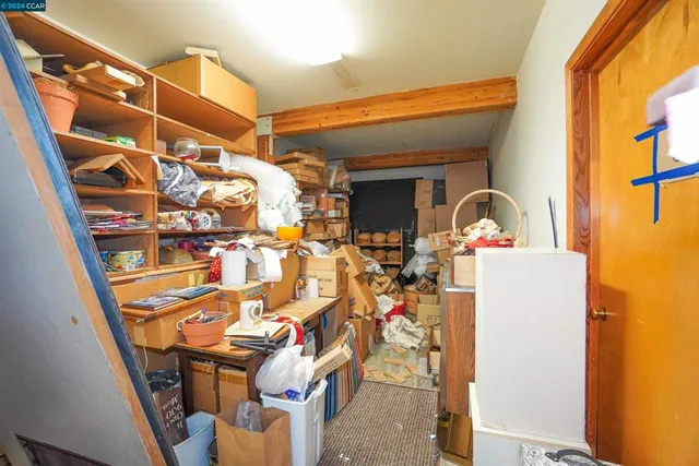 a view of a living room with a sink and a mirror