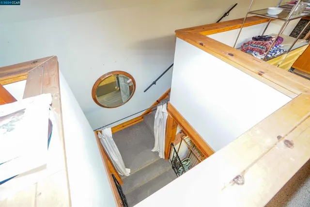 a view of a balcony with furniture and floor to ceiling window