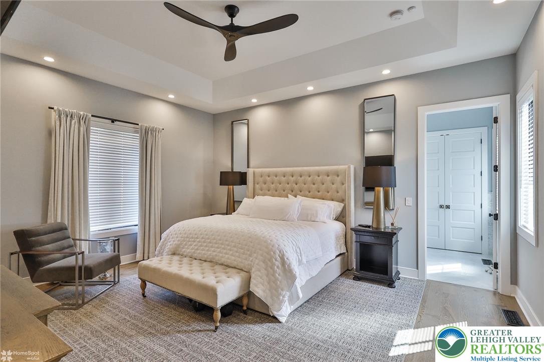 4850 West Hopewell Road Center Valley, PA 18034 - Photo 58 of 96 a spacious bedroom with a bed and a couch