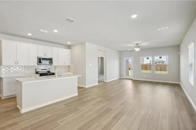 a view of a kitchen with a sink and a stove top oven