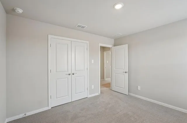 a view of an empty room and closet area