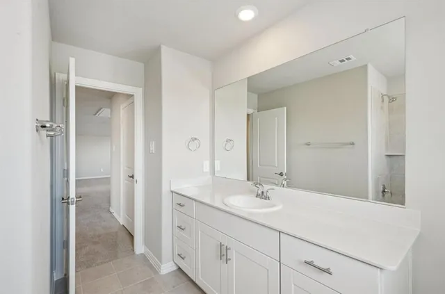 a bathroom with a sink double vanity and a mirror