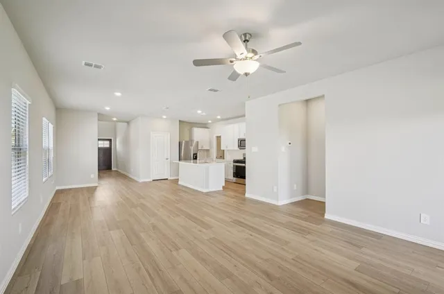 a view of a kitchen with a sink and a refrigerator