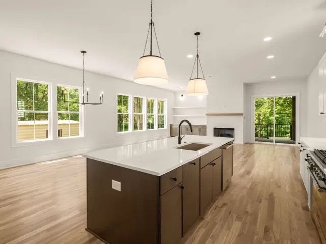 a view of empty room with wooden floor and fireplace