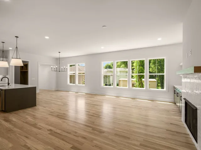 a view of a room with wooden floor and windows