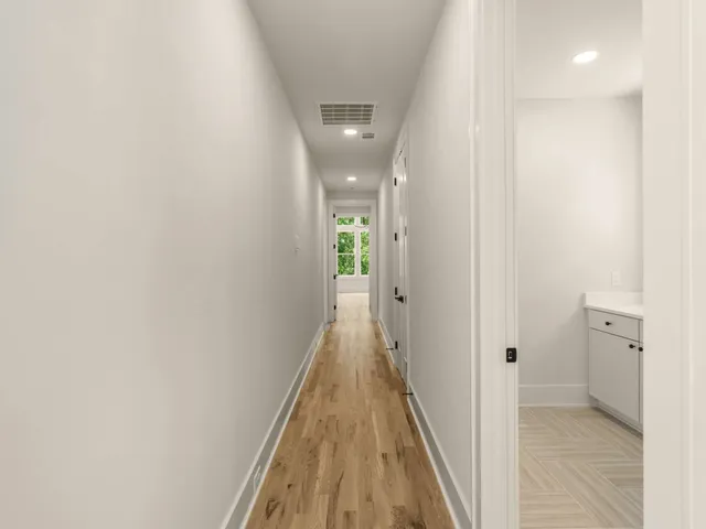 a view of an empty room and wooden floor