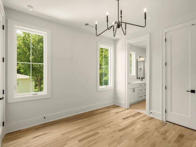 a bathroom with a sink shower and a mirror