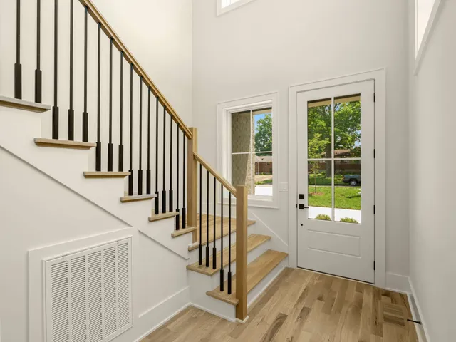 a view of entryway and hall with wooden floor