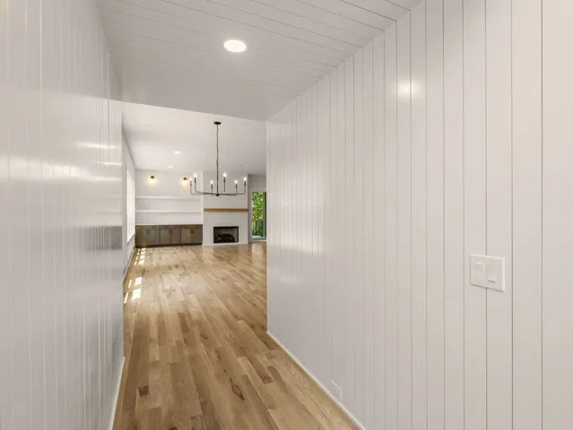 a large kitchen with kitchen island a sink stainless steel appliances and a fireplace