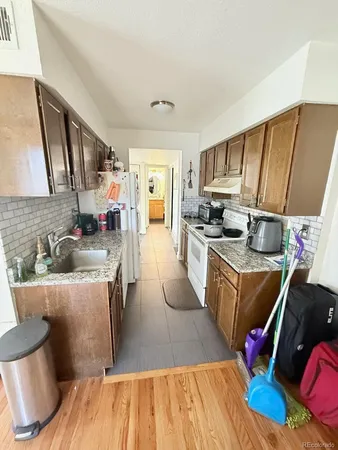 a kitchen with a sink appliances and cabinets
