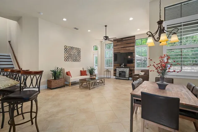 a living room with furniture and a view of kitchen