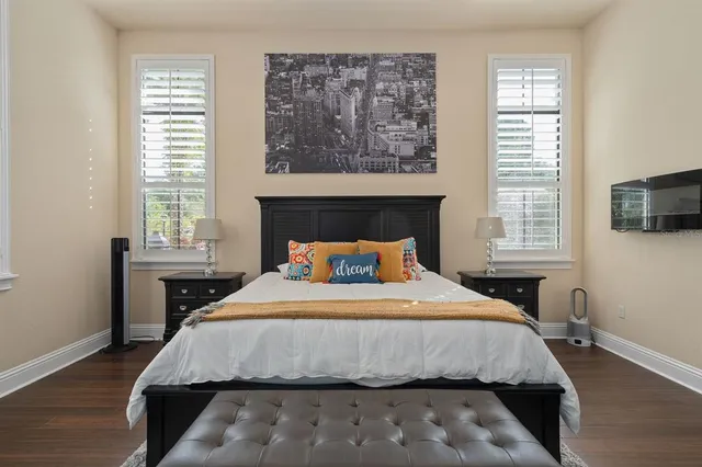 a bathroom with a tub a double vanity sink and a mirror