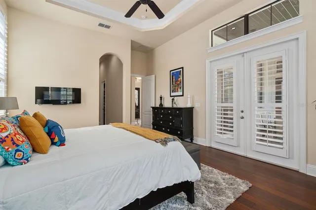 a bathroom with a granite countertop sink a toilet a mirror and shower