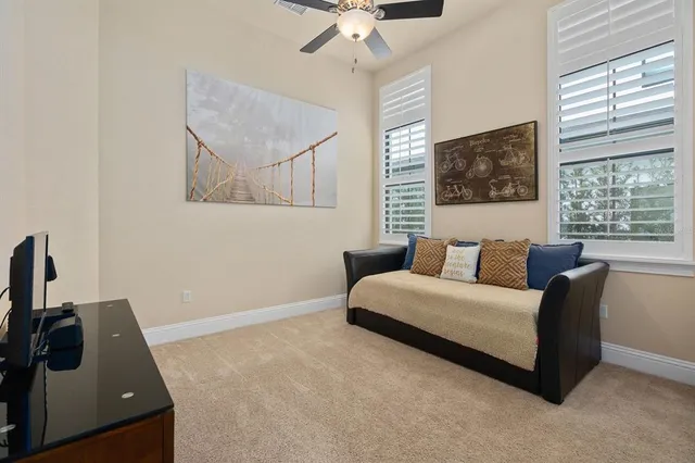 a bedroom with a bed and a painting on the wall