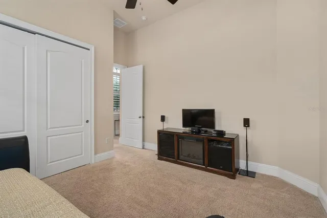 a bathroom with a granite countertop bathtub sink vanity mirror and toilet