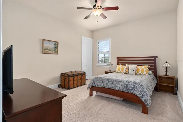 a bathroom with a granite countertop sink a toilet and a mirror