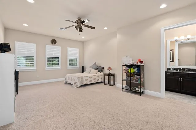 a patio with a table and chairs and potted plants