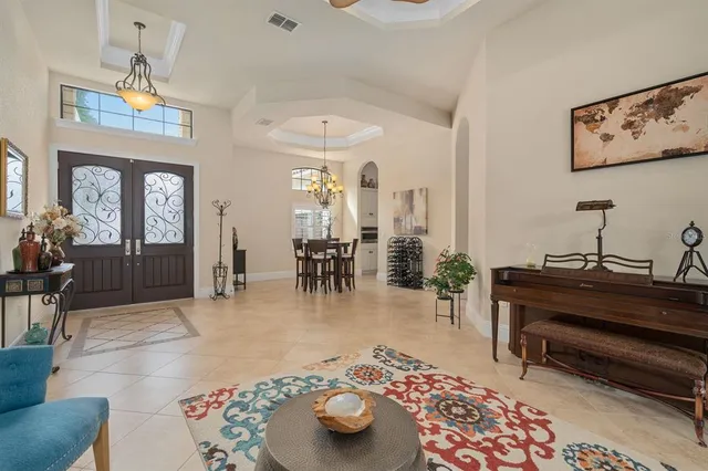 a kitchen with kitchen island stainless steel appliances a table chairs sink and cabinets
