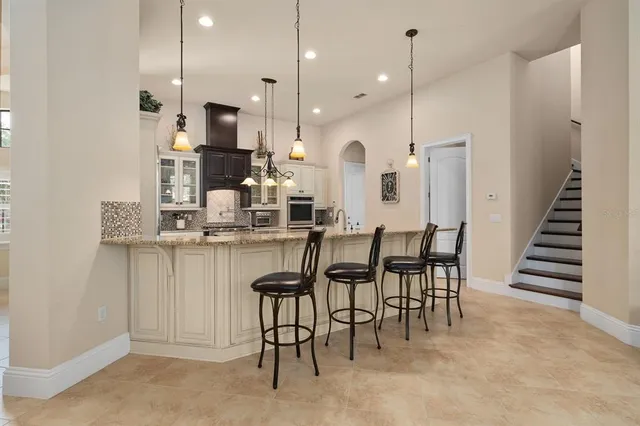 a kitchen with stainless steel appliances granite countertop a stove sink and cabinets