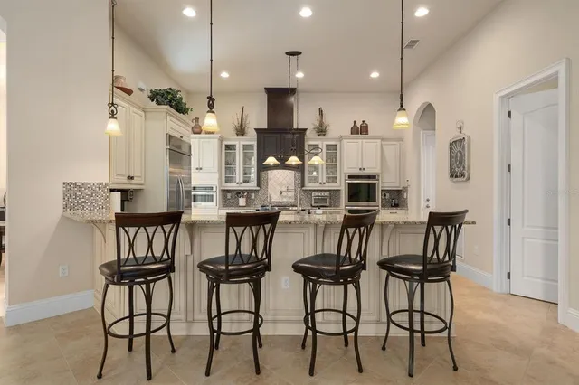 a kitchen with stainless steel appliances granite countertop a sink a stove and a granite counter tops