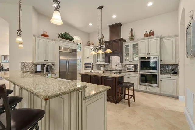 a kitchen with stainless steel appliances granite countertop a stove and cabinets