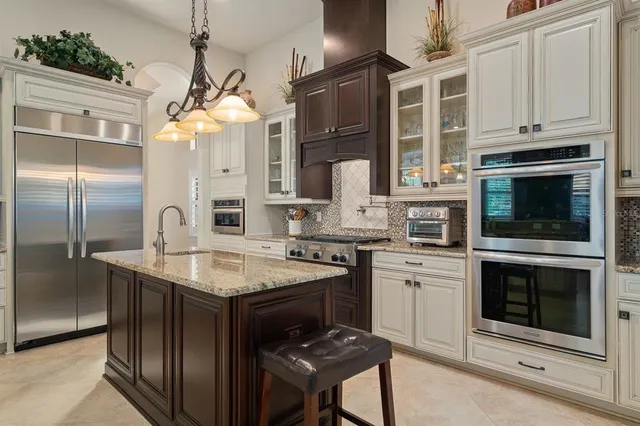 a kitchen with stainless steel appliances granite countertop a stove and a sink