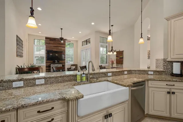 a kitchen with kitchen island a sink stove and refrigerator with a large island