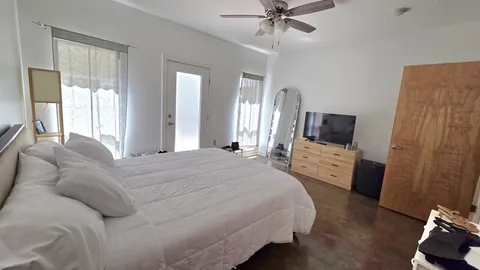 a bedroom with a bed and a flat screen tv