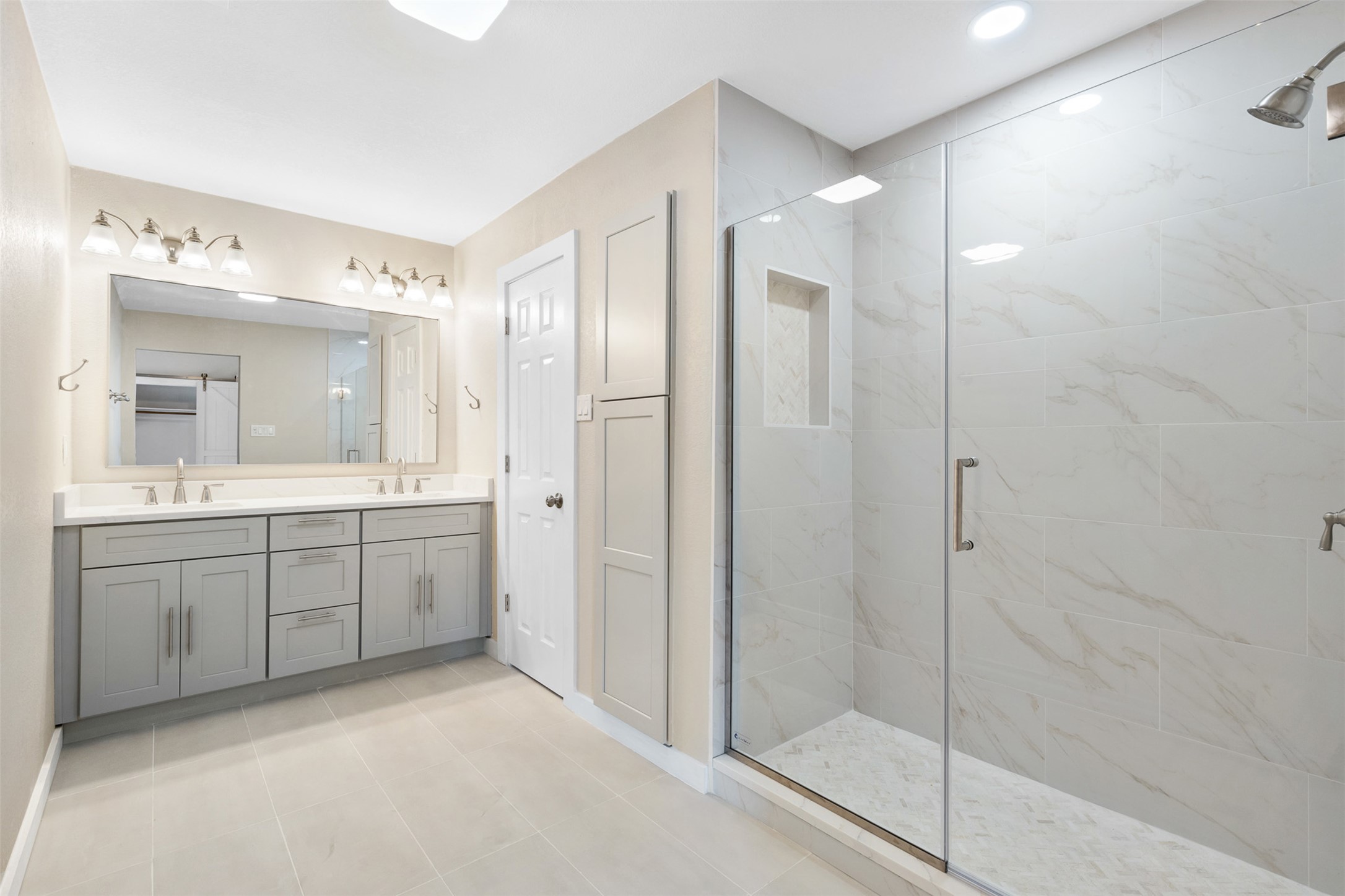 3203 Freemont Street Round Rock, TX 78681 - Photo 14 of 33 a bathroom with a double vanity sink mirror and shower