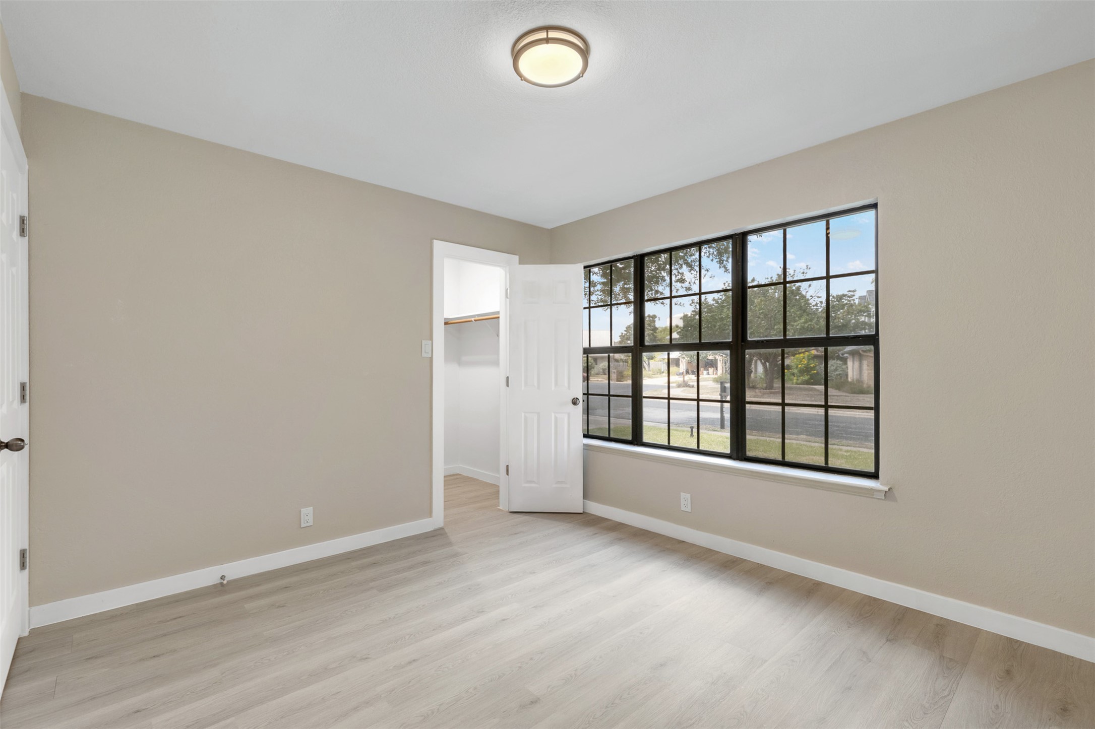 3203 Freemont Street Round Rock, TX 78681 - Photo 19 of 33 an empty room with wooden floor and windows