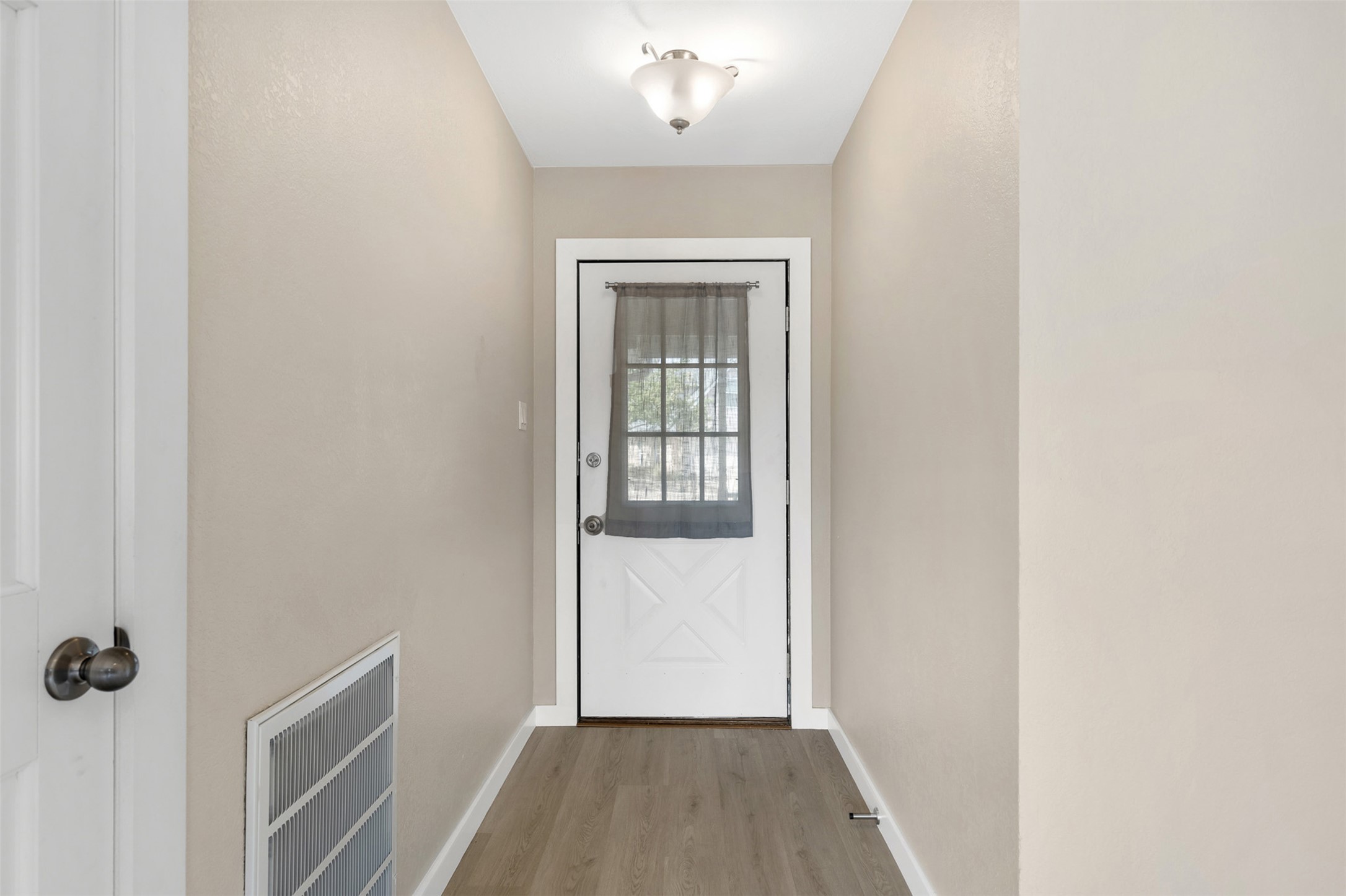 3203 Freemont Street Round Rock, TX 78681 - Photo 5 of 33 a view of a hallway with wooden floor and a bathroom