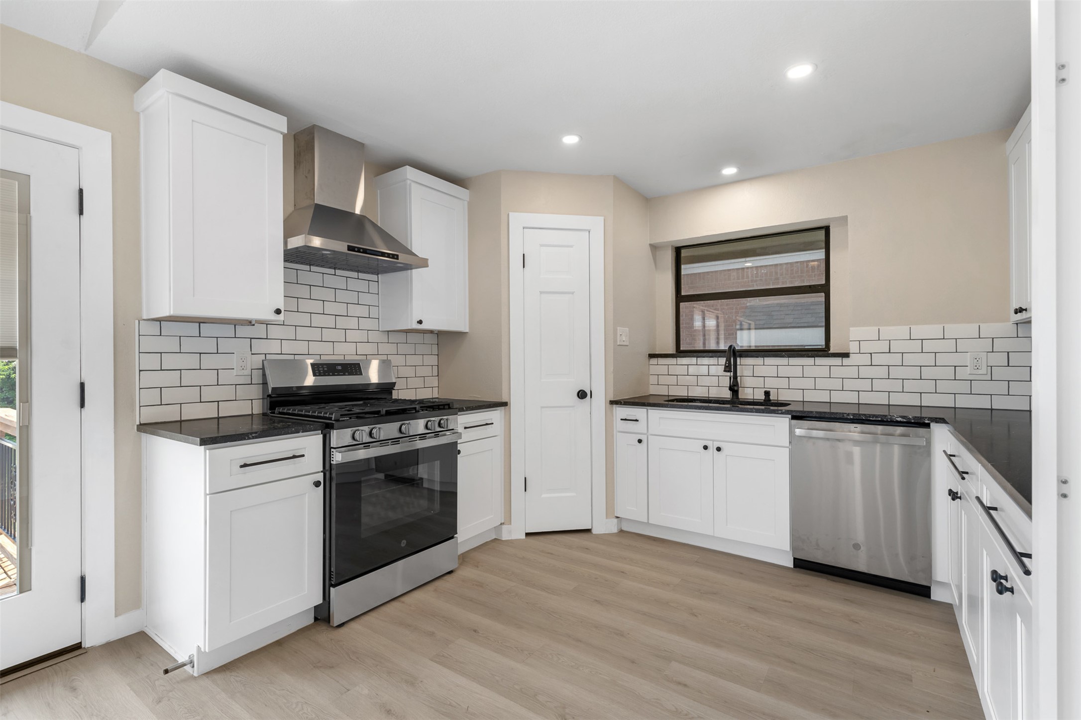 3203 Freemont Street Round Rock, TX 78681 - Photo 9 of 33 a kitchen with stainless steel appliances granite countertop a stove and a sink