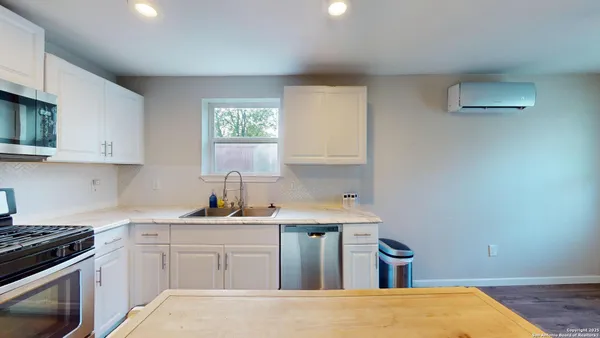 a kitchen with a stove a sink and a microwave