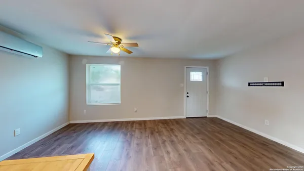 wooden floor in an empty room with a window