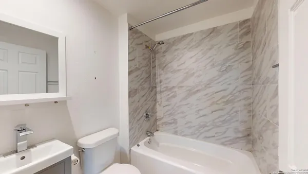 a bathroom with a bathtub and shower