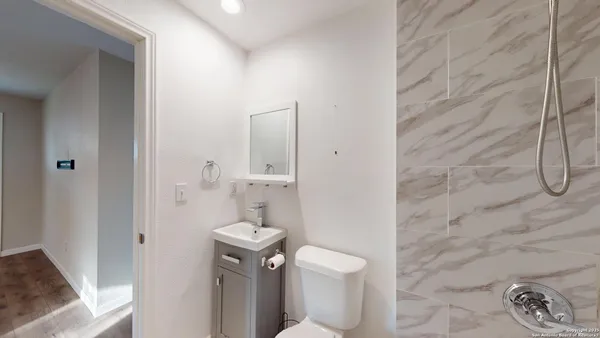 a bathroom with a toilet and a shower
