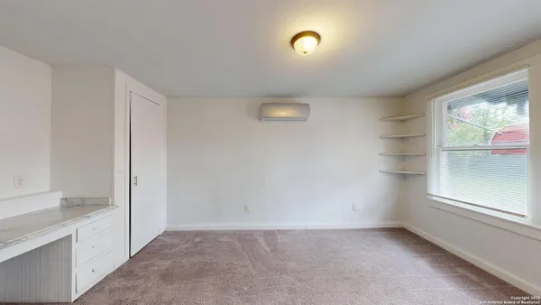 a view of an empty room with a window