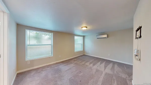 an empty room with windows and closet