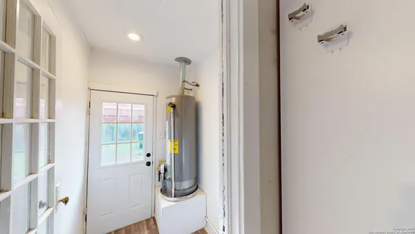 a view of a hallway with a shower and a fireplace