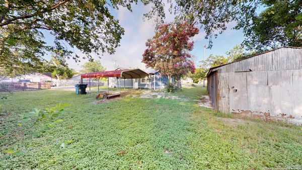 a view of backyard with tub and trees