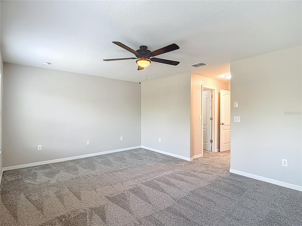 20451 Berrywood Lane Tampa, FL 33647 - Photo 31 of 57 an empty room with closet and a ceiling fan