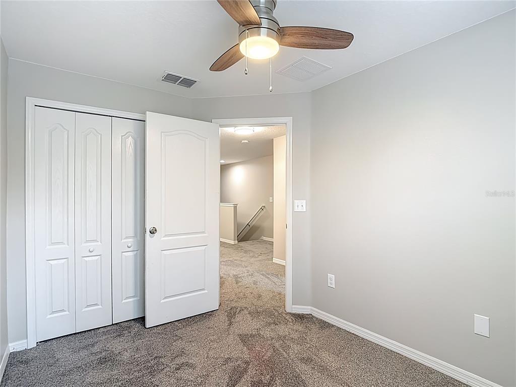 20451 Berrywood Lane Tampa, FL 33647 - Photo 42 of 57 an empty room with closet and a chandelier fan
